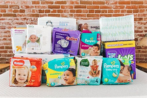 packs of diapers from various brands piled up on a table