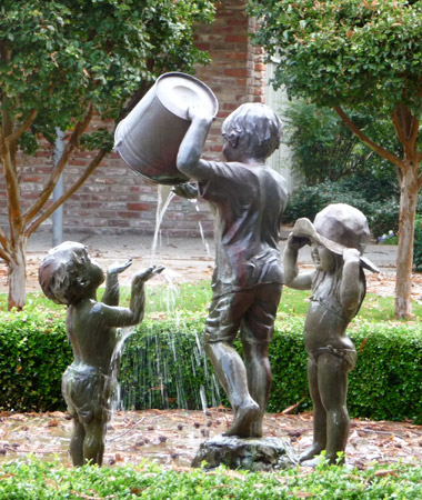 fountain of three child statues with water