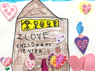 child's drawing of a school with the words I love Childrens Center'